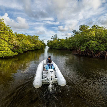 Suzuki 30 HP White Remote in Use on Dinghy Back View