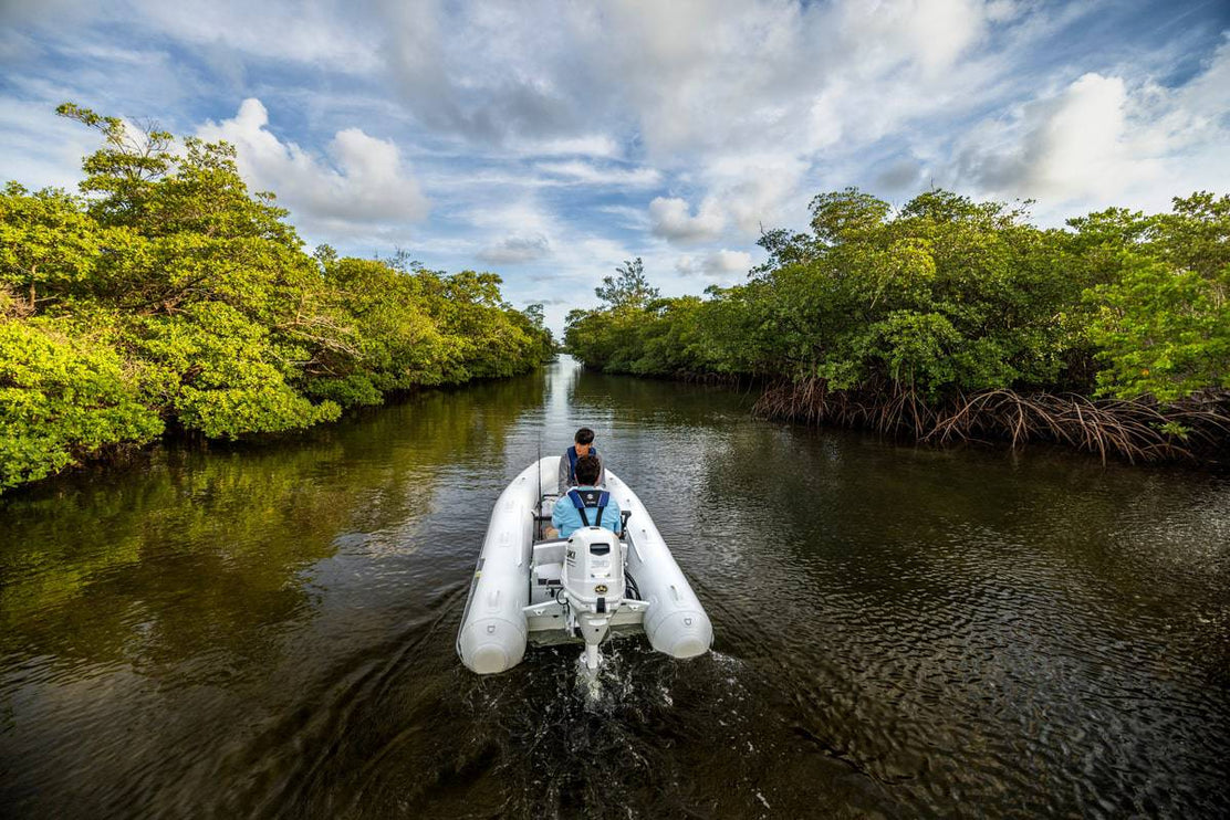 Suzuki 30 HP White Remote in Use on Dinghy Back View