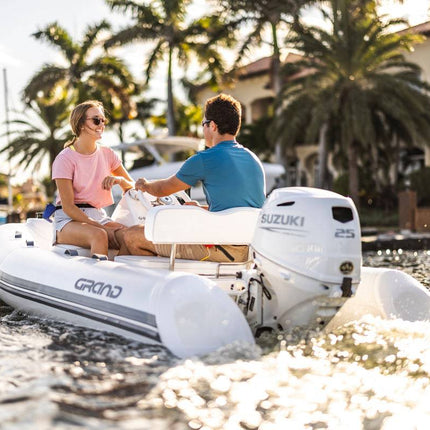 Suzuki 25 HP White Remote in Use on Dinghy Back View